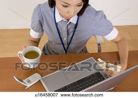 Young woman eating sandwiches at desk View Large Photo Image Stock Photo - Young woman eating sandwiches at desk. Fotosearch
