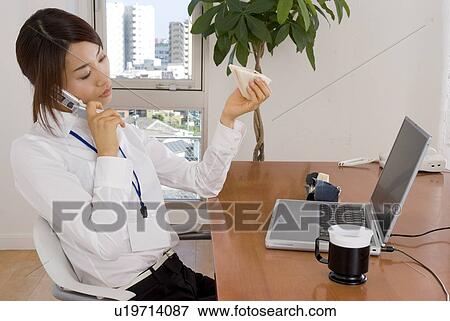 Young woman eating sandwiches at desk View Large Photo Image Stock Photo - Young woman eating sandwiches at desk. Fotosearch