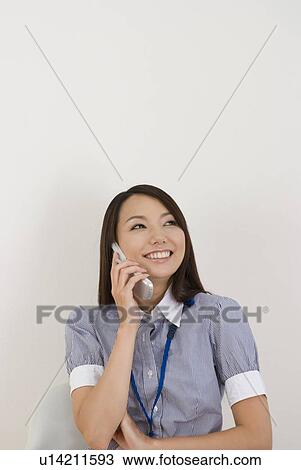 Young woman talking over mobile phone View Large Photo Image Stock Image - Young woman talking over mobile phone. Fotosearch