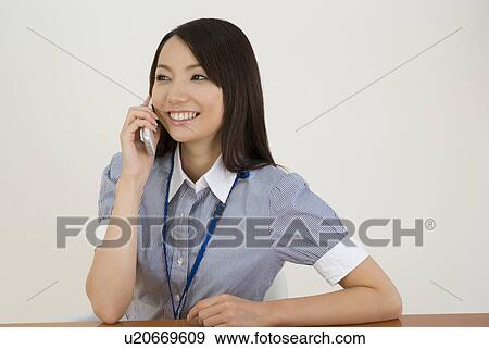 Young woman talking over mobile phone View Large Photo Image Stock Photo - Young woman talking over mobile phone. Fotosearch
