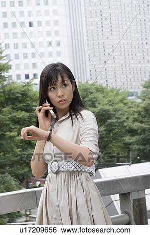 Young woman talking over mobile phone View Large Photo Image Stock Photograph - Young woman talking over mobile phone. Fotosearch