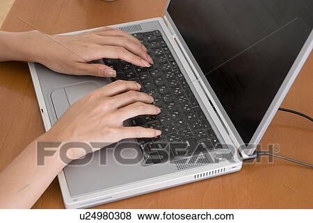 Stock Photo - Young woman typing computer. Fotosearch
