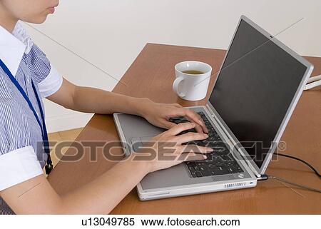 Young woman using computer View Large Photo Image Stock Photography - Young woman using computer. Fotosearch