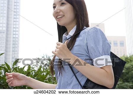 Stock Image - Young woman walking. Fotosearch