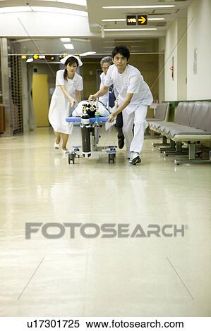 Doctor and nurses transporting patient on stretcher View Large Photo Image Stock Photography - Doctor and nurses transporting patient on stretcher. Fotosearch