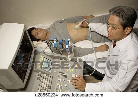 Picture - Doctor examining patient with ultrasound. Fotosearch