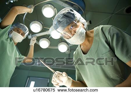 Stock Photography - Doctor holding clamp. Fotosearch