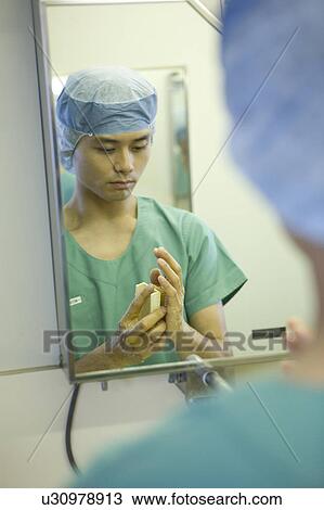 Doctor washing hands View Large Photo Image Stock Image - Doctor washing hands. Fotosearch