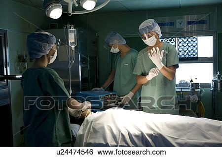 Stock Photograph - Doctors preparing operation. Fotosearch