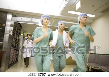 Doctors running in hospital View Large Photo Image Stock Photo - Doctors running in hospital. Fotosearch