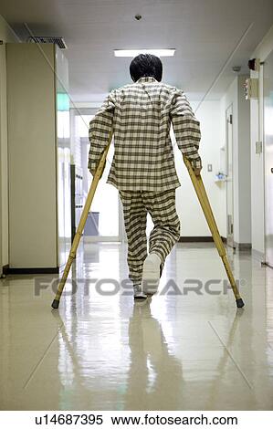 Man walking with crutches View Large Photo Image Stock Photography - Man walking with crutches. Fotosearch