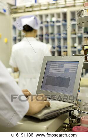 Stock Photograph - Nurse entering data. Fotosearch