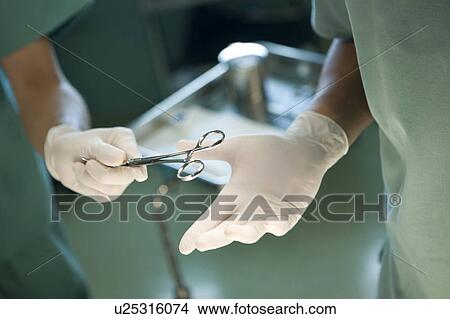 Nurse giving doctor clamp View Large Photo Image Picture - Nurse giving doctor clamp. Fotosearch