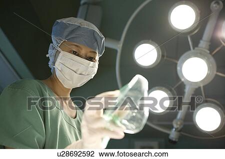 Stock Image - Nurse holding oxygen mask. Fotosearch