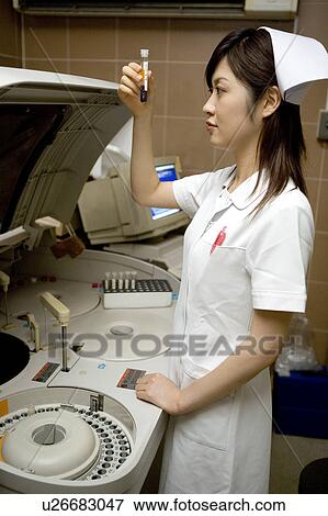 Stock Photo - Nurse holding test tube. Fotosearch