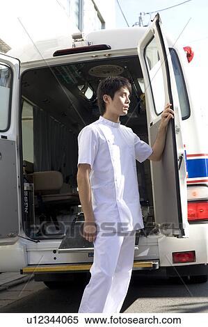 Stock Photography - Nurse opening door of ambulance. Fotosearch