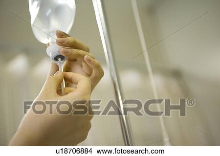 Nurse preparing IV drip View Large Photo Image Picture - Nurse preparing IV drip. Fotosearch