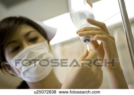 Nurse preparing IV drip View Large Photo Image Stock Photo - Nurse preparing IV drip. Fotosearch