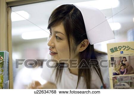 Stock Photo - Nurse working at reception. Fotosearch