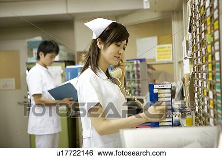Nurses working in nurses station View Large Photo Image Stock Photograph - Nurses working in nurses station. Fotosearch