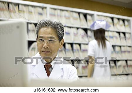 Pharmacists working in pharmacy View Large Photo Image Stock Image - Pharmacists working in pharmacy. Fotosearch