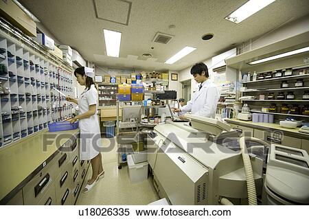 Stock Photography - Pharmacists working in pharmacy. Fotosearch