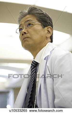 Stock Photography - Portrait of mature doctor. Fotosearch