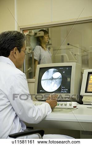 Technician looking at X-ray image View Large Photo Image Stock Image - Technician looking at X-ray image. Fotosearch