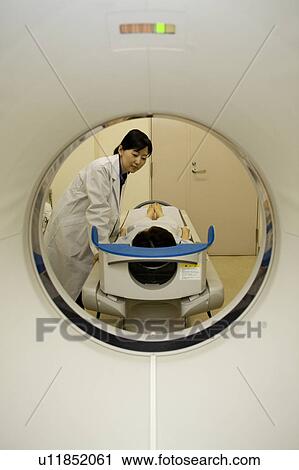 Young woman lying on CAT Scan View Large Photo Image Stock Image - Young woman lying on CAT Scan. Fotosearch