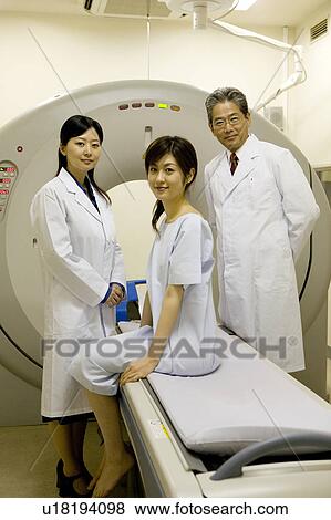 Stock Photo - Young woman sitting on CAT Scan. Fotosearch