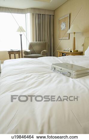 Picture - Business bag on bed. Fotosearch