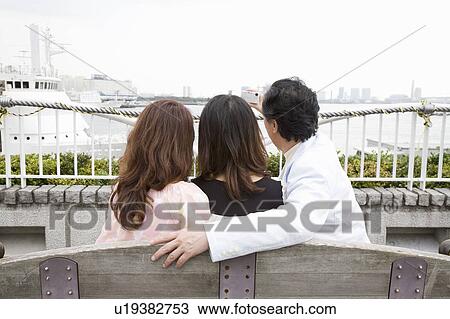 Stock Image - Family photographing themselves. Fotosearch