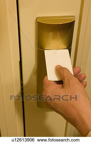 Man opening door with cardkey View Large Photo Image Stock Photograph - Man opening door with cardkey. Fotosearch