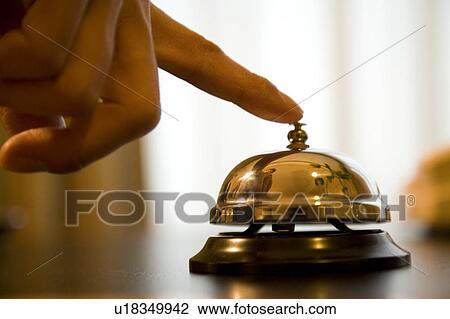 Stock Image - Man ringing service bell. Fotosearch