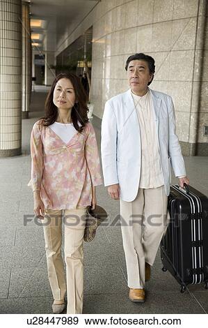 Mature couple leaving hotel View Large Photo Image Stock Photo - Mature couple leaving hotel. Fotosearch