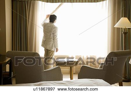 Mature man looking through window View Large Photo Image Stock Photo - Mature man looking through window. Fotosearch