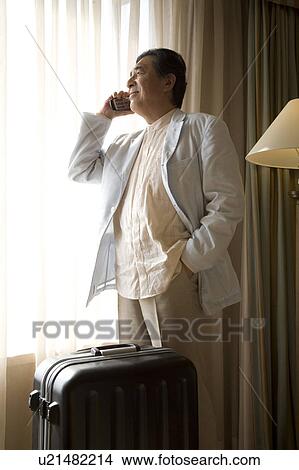 Picture - Mature man talking over cell phone. Fotosearch