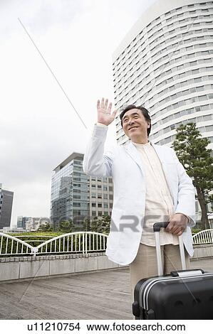 Picture - Mature man waving hand. Fotosearch