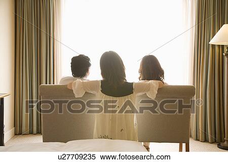 Parents and daughter looking through window View Large Photo Image Stock Photography - Parents and daughter looking through window. Fotosearch