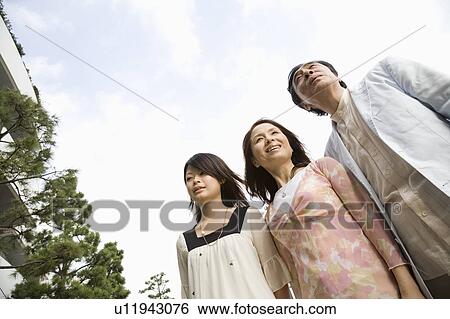 Parents and daughter standing View Large Photo Image Stock Photograph - Parents and daughter standing. Fotosearch