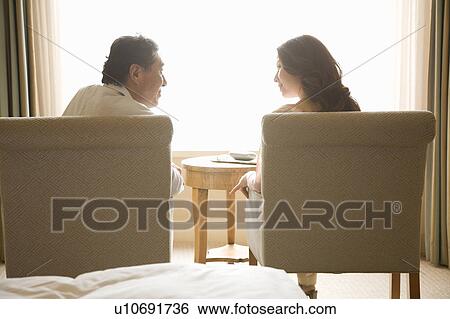 Rear view of mature couple talking View Large Photo Image Stock Photograph - Rear view of mature couple talking. Fotosearch