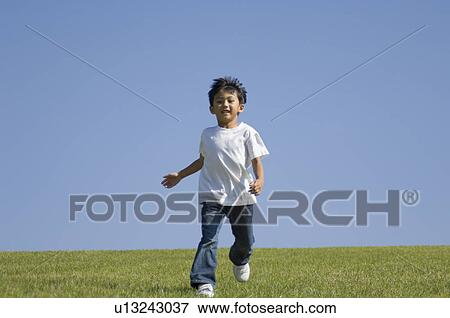 Stock Photo - Boy running in field. Fotosearch