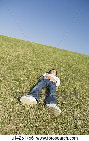 Boy sleeping in field View Large Photo Image Stock Photograph - Boy sleeping in field. Fotosearch
