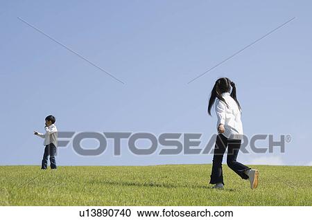 Children playing in field View Large Photo Image Stock Image - Children playing in field. Fotosearch