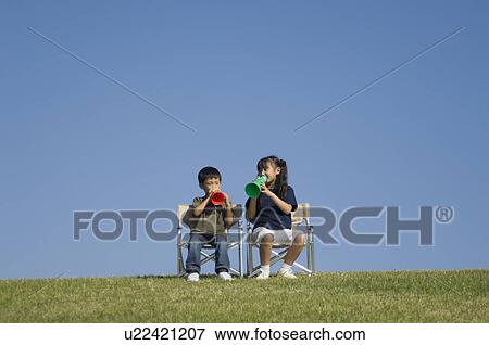 Stock Photo - Children talking with megaphone. Fotosearch