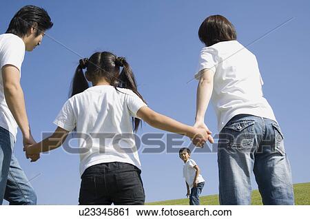 Stock Image - Family holding hands. Fotosearch