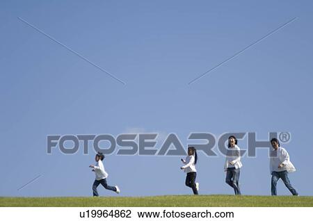 Family running in field View Large Photo Image Stock Image - Family running in field. Fotosearch