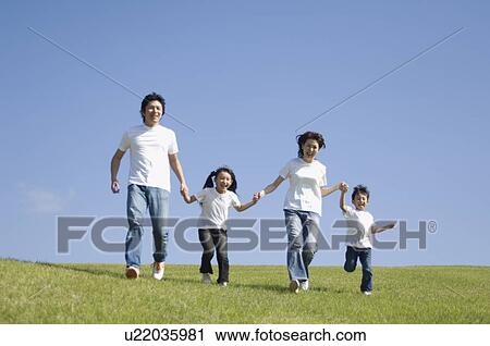 Family running in field View Large Photo Image Stock Image - Family running in field. Fotosearch