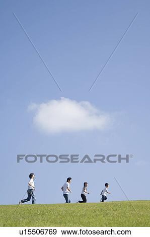 Stock Photo - Family running in field. Fotosearch