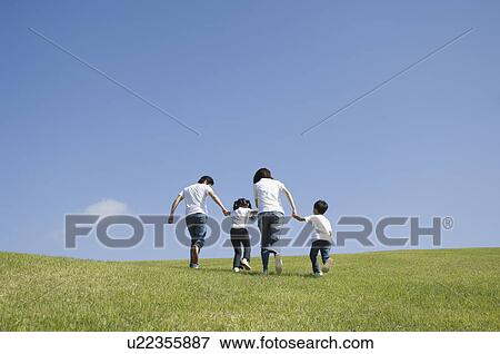 Stock Photo - Family running in field. Fotosearch